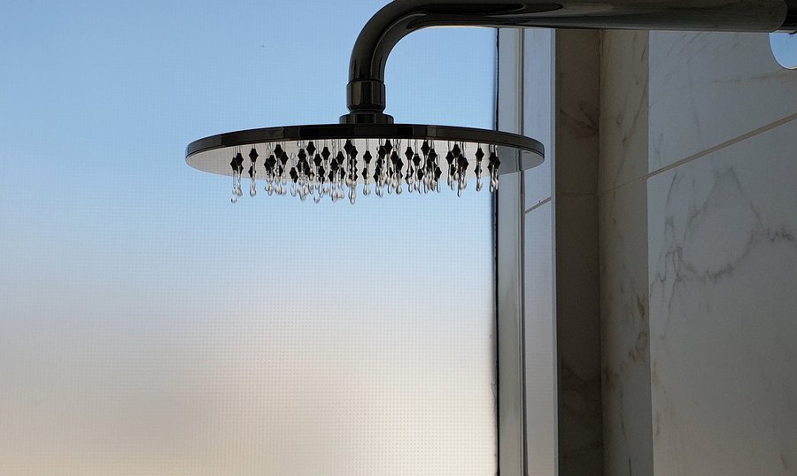Luxurious hotel shower with mounted metalic shower head